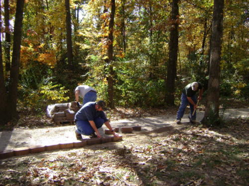 The Arkansas State University ATA and the Arkansas Forestry Commission working on the walkway
